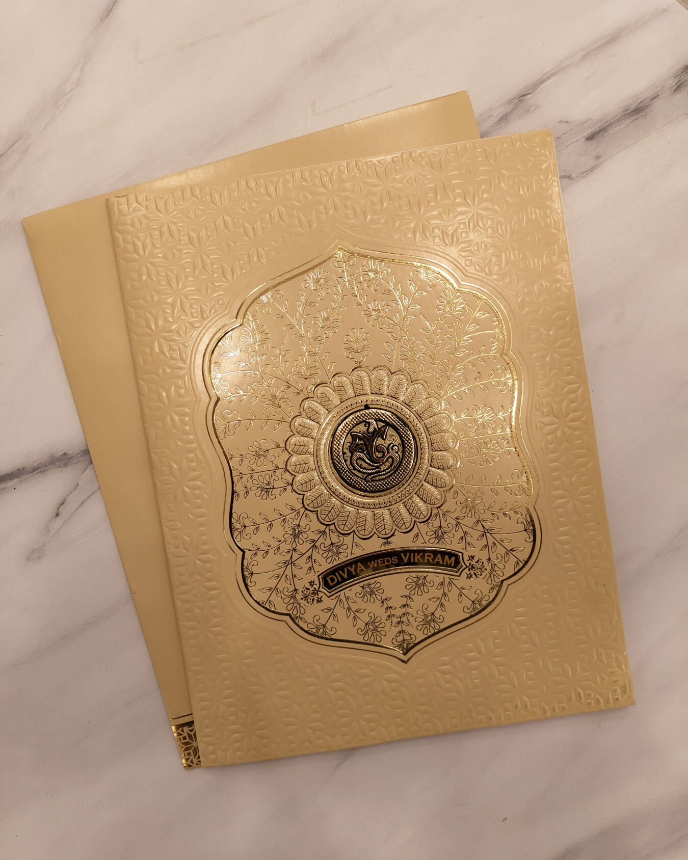 Gold Embossed Floral Wedding Invitation Card with Acrylic Nameplate & Customisable Emblem | Matching Envelope